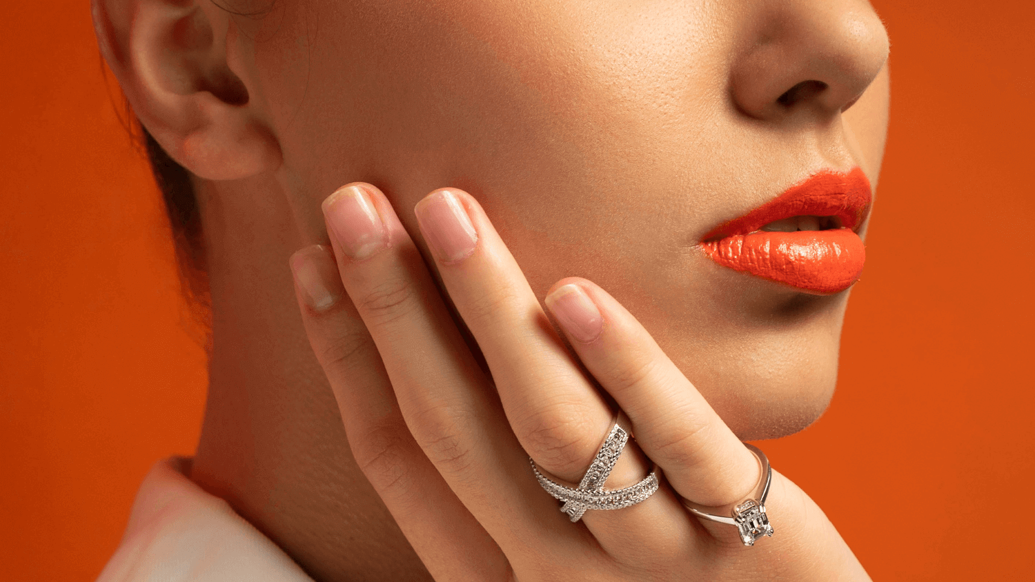 young woman wearing charm silver rings orange color